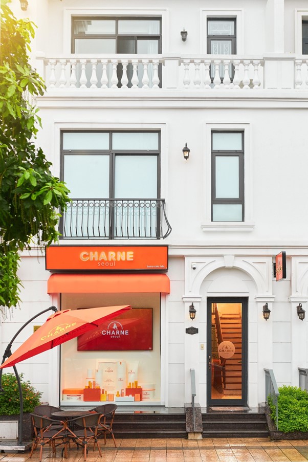 A building with a white wall and a red awningAI-generated content may be incorrect.